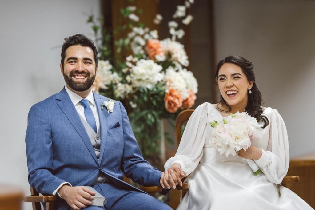 Novios durante la ceremonia riendo felices